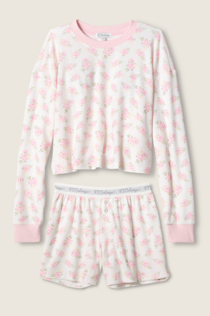 The Boyfriend Boxer Ditsy Floral Shorts Set by P.J. Salvage features a matching long-sleeve top with pink cuffs and floral print, paired with white button-front shorts with an elastic waistband and subtle P.J. Salvage branding.