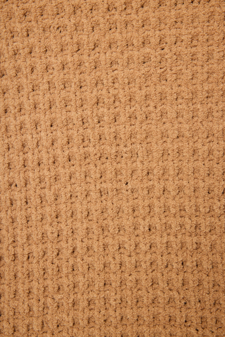 Close-up of the P.J. Salvage Chenille Waffle Solid Caramel Sweater, highlighting its textured surface with a grid-like waffle pattern and raised, evenly spaced ridges.