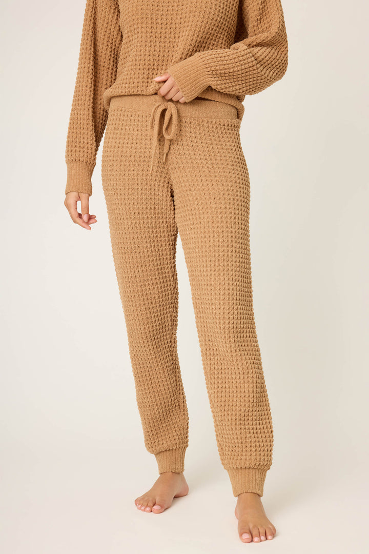 A person stands barefoot wearing P.J. Salvage's Chenille Waffle Solid Caramel Banded Pant, shown from mid-chest down against a plain background.