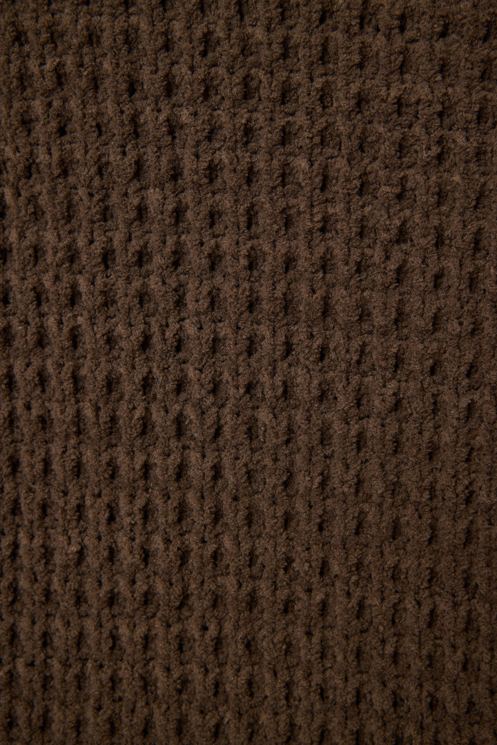Close-up of the P.J. Salvage Chenille Waffle Solid Chocolate Banded Pant, featuring brown textured fabric with a grid-like waffle pattern, vertical ridges, and a soft, fuzzy surface.