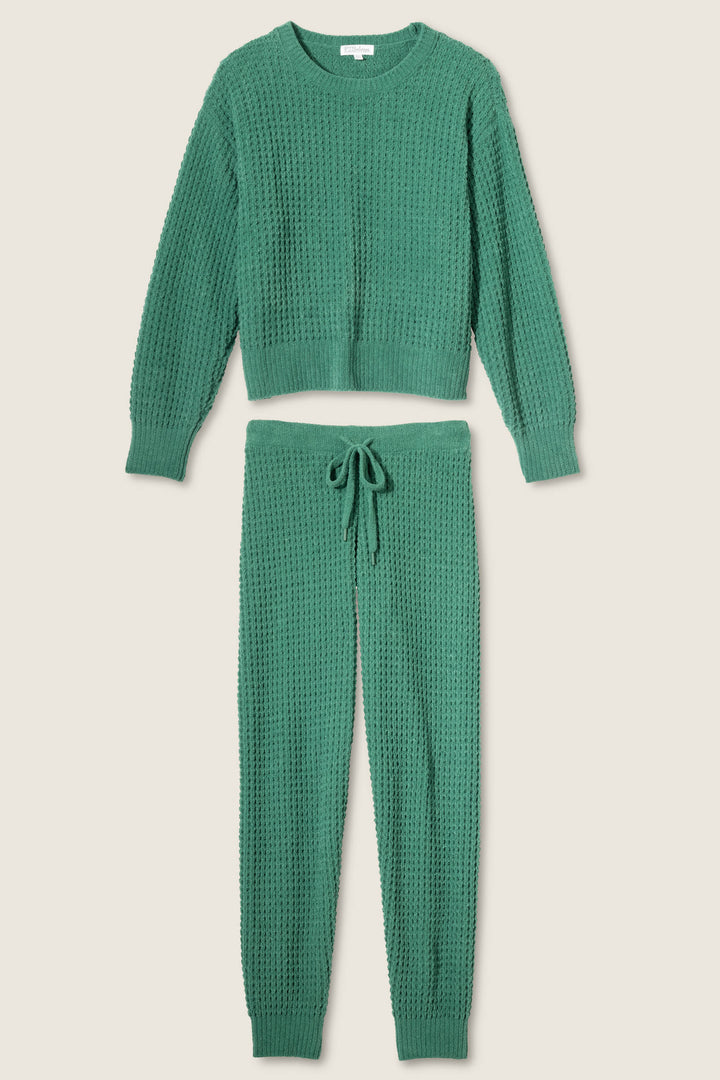 The P.J. Salvage Chenille Waffle Solid Forest Lounge Set features a green textured knit long-sleeve crewneck sweater and matching drawstring pants, both shown flat on a neutral background.