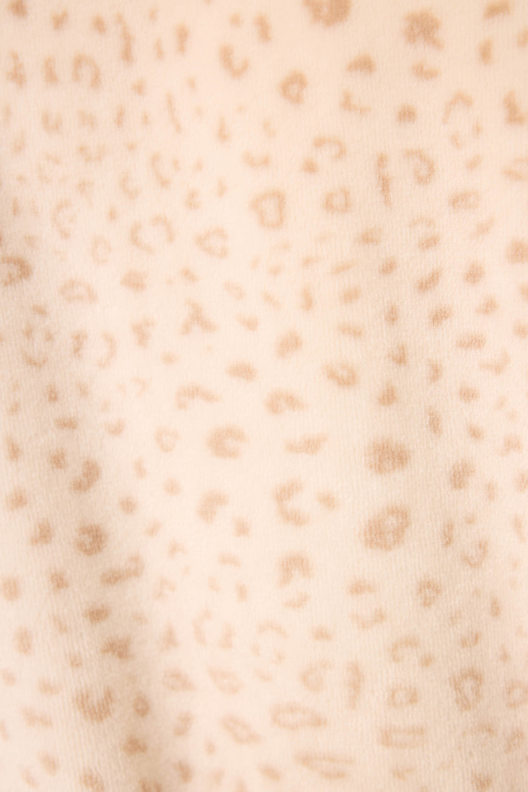 Close-up of the Luxe Plush Leopard Print Robe by P.J. Salvage, featuring soft beige fabric with a light brown, irregular leopard print pattern and a slightly fuzzy texture for added comfort.