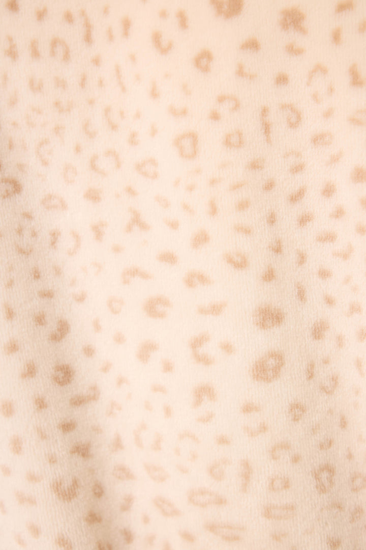Close-up of the Luxe Plush Leopard Print Robe by P.J. Salvage, featuring soft beige fabric with a light brown, irregular leopard print pattern and a slightly fuzzy texture for added comfort.