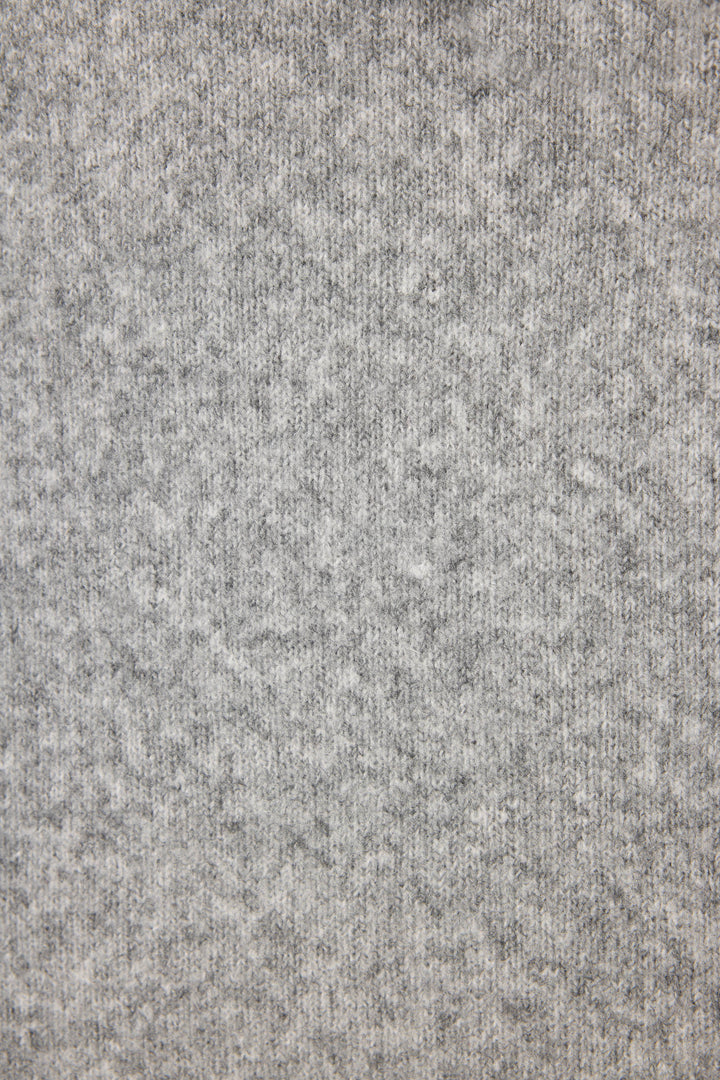 Close-up of the light gray, heathered knit fabric of the P.J. Salvage Doggone Cold Sweater Weather Graphic Knit Hoodie, featuring a soft, subtly textured appearance with small variations in gray shades.