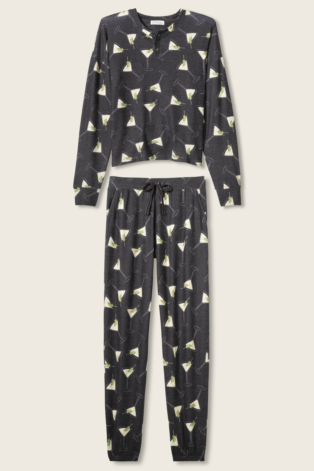 The Merrier With A Martini PJ Set by P.J. Salvage features a long-sleeve top and drawstring pants in dark fabric with an all-over martini glass print, displayed flat on a light background.