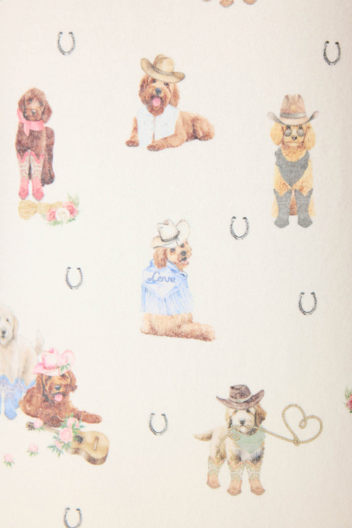 P.J. Salvage DOGS OPEN LEG PANT RUFF ON THE RANGE features patterned fabric with dogs in cowboy hats, boots, and bandanas, plus horse shoe symbols on a light background—some pups interacting with western-themed props.