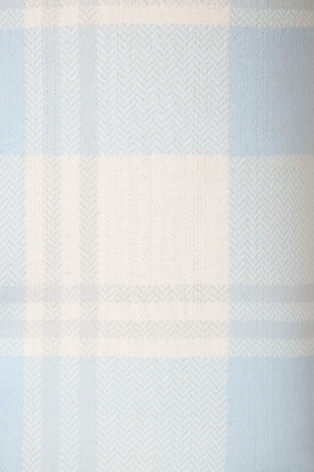 A close-up of the Pointelle Essentials Plaid 4-Piece Loungewear Set by P.J. Salvage, showcasing its light blue and white plaid fabric with horizontal and vertical stripes and a herringbone texture.