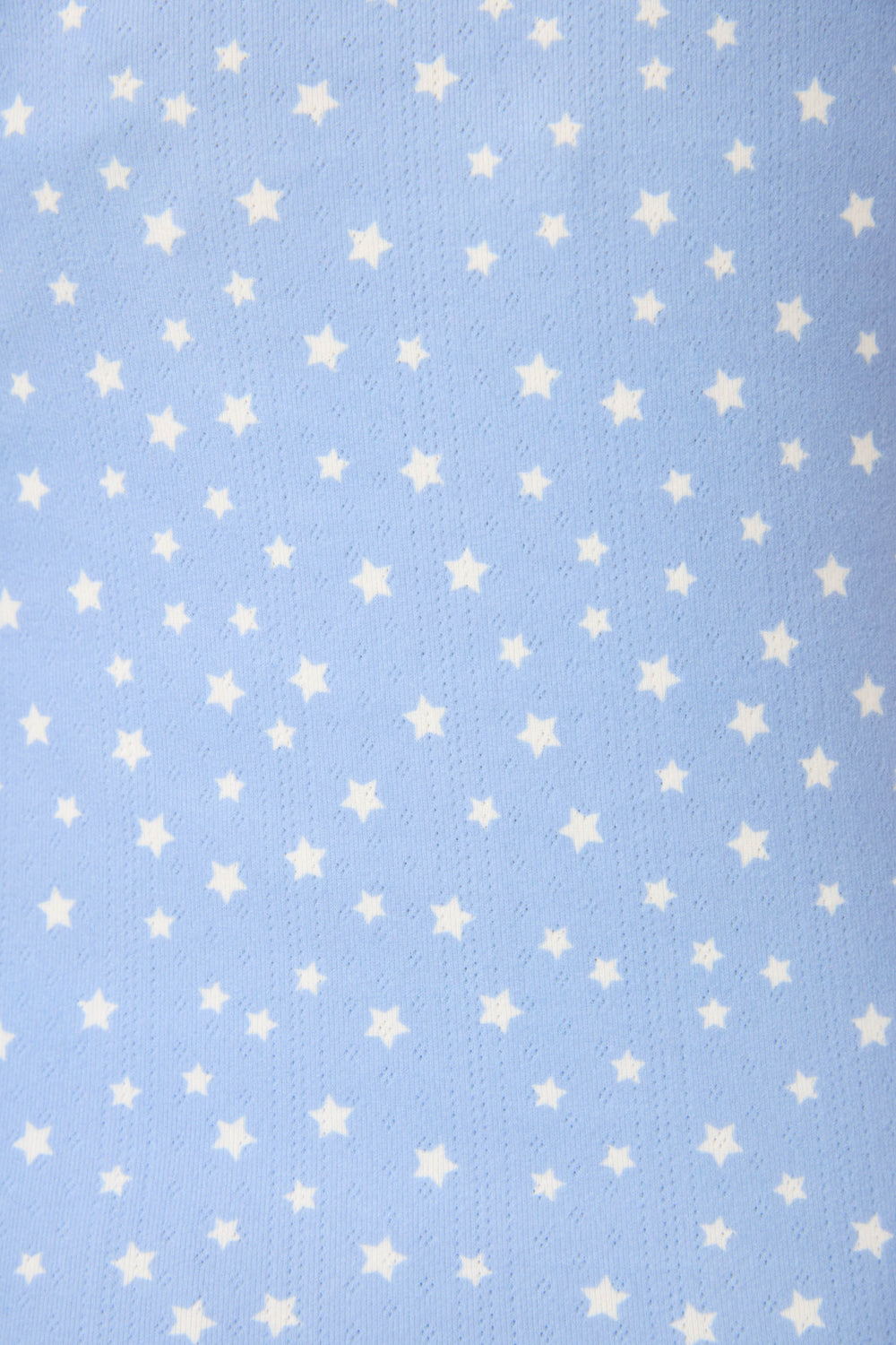 The Pointelle Essentials Ditsy Star 4-Piece Loungewear Set by P.J. Salvage features soft, light blue fabric with a subtle texture and a pattern of small, evenly spaced white stars.