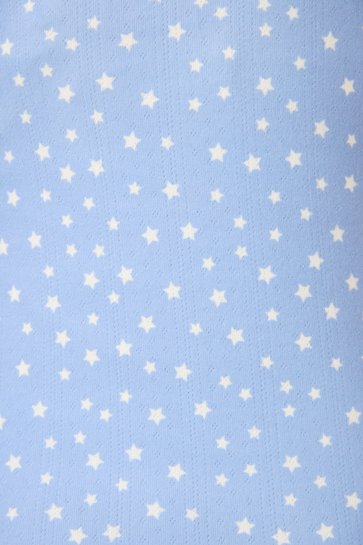 The Pointelle Essentials Ditsy Star 4-Piece Loungewear Set by P.J. Salvage features soft, light blue fabric with a subtle texture and a pattern of small, evenly spaced white stars.