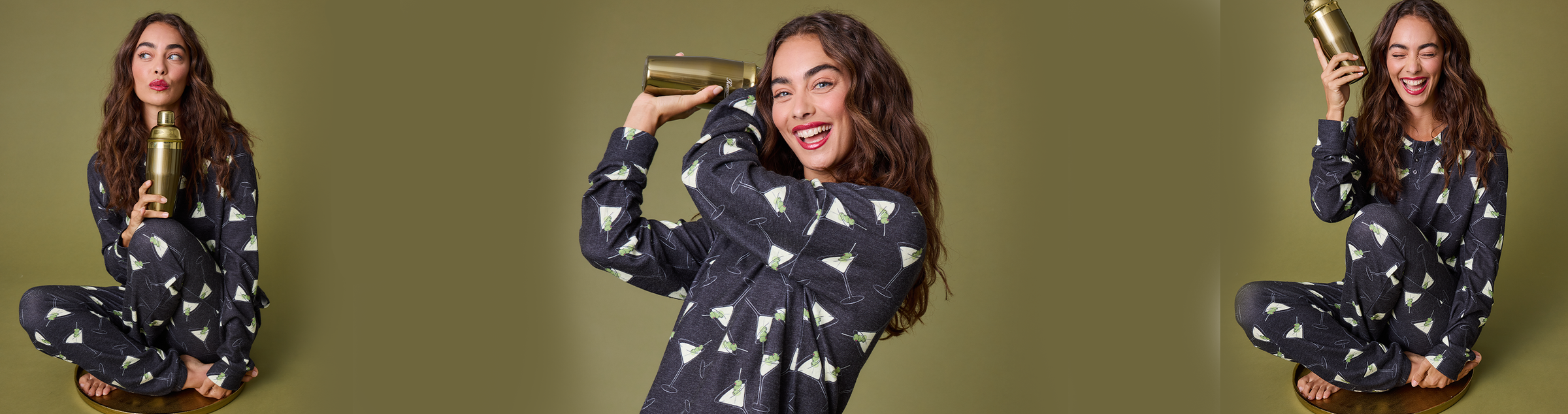 Person with curly hair lying on their back and smiling, wearing light-colored pajamas with a colorful print. Their arms are raised above their head, and the background is plain and neutral.