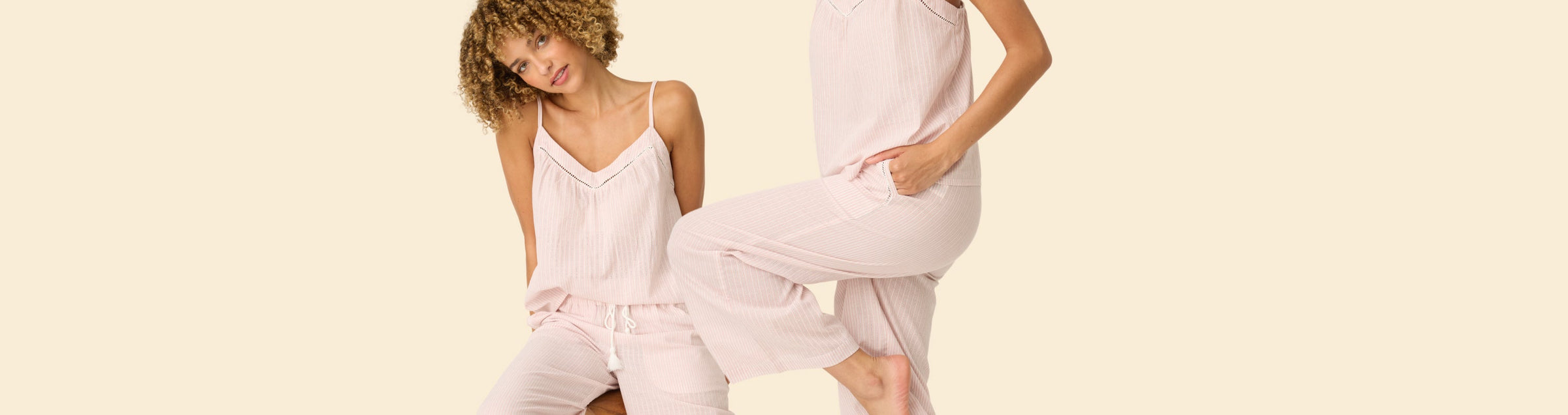 Five women wearing different colored lounge or pajama sets pose in front of a neutral background. Each outfit features a unique graphic print and drawstring pants. Faces are partially visible or out of frame.