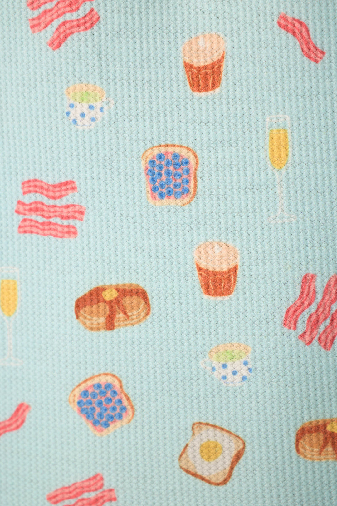 The Boyfriend Boxer Sunday Brunch Short PJ Set by P.J. Salvage features a light blue fabric printed with breakfast items like bacon, toast, pancakes, coffee cups, and orange juice for a playful morning look.