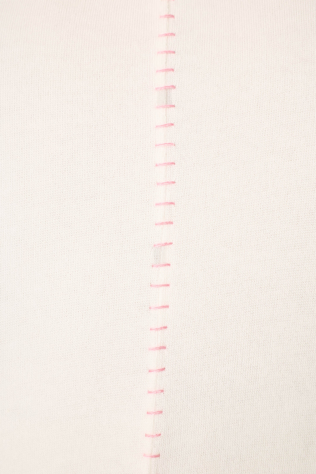 Close-up of the Cheeky Paradise Sweatshirt by P.J. Salvage, highlighting its white fabric with a row of evenly spaced, vertical pink stitches down the center seam.