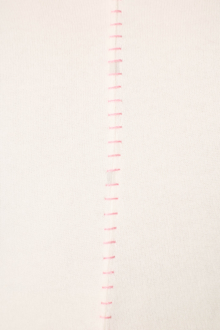 Close-up of the Cheeky Paradise Sweatshirt by P.J. Salvage, highlighting its white fabric with a row of evenly spaced, vertical pink stitches down the center seam.