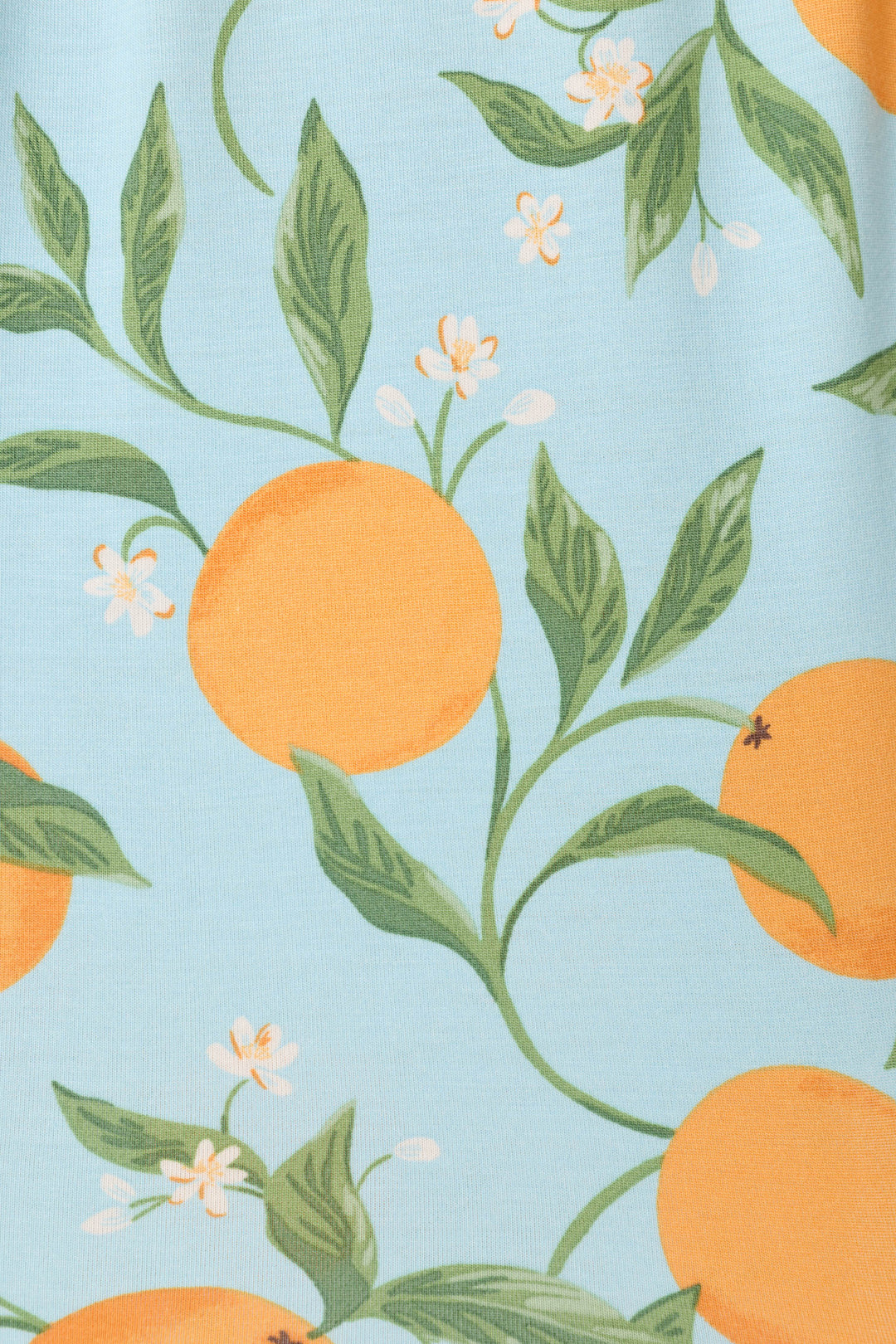The P.J. Salvage Citrus Dreams Morning Squeeze styles features soft jersey fabric with a vibrant citrus fruit, green leaf, and white flower print on a light blue background—perfect for cozy, refreshing nights.