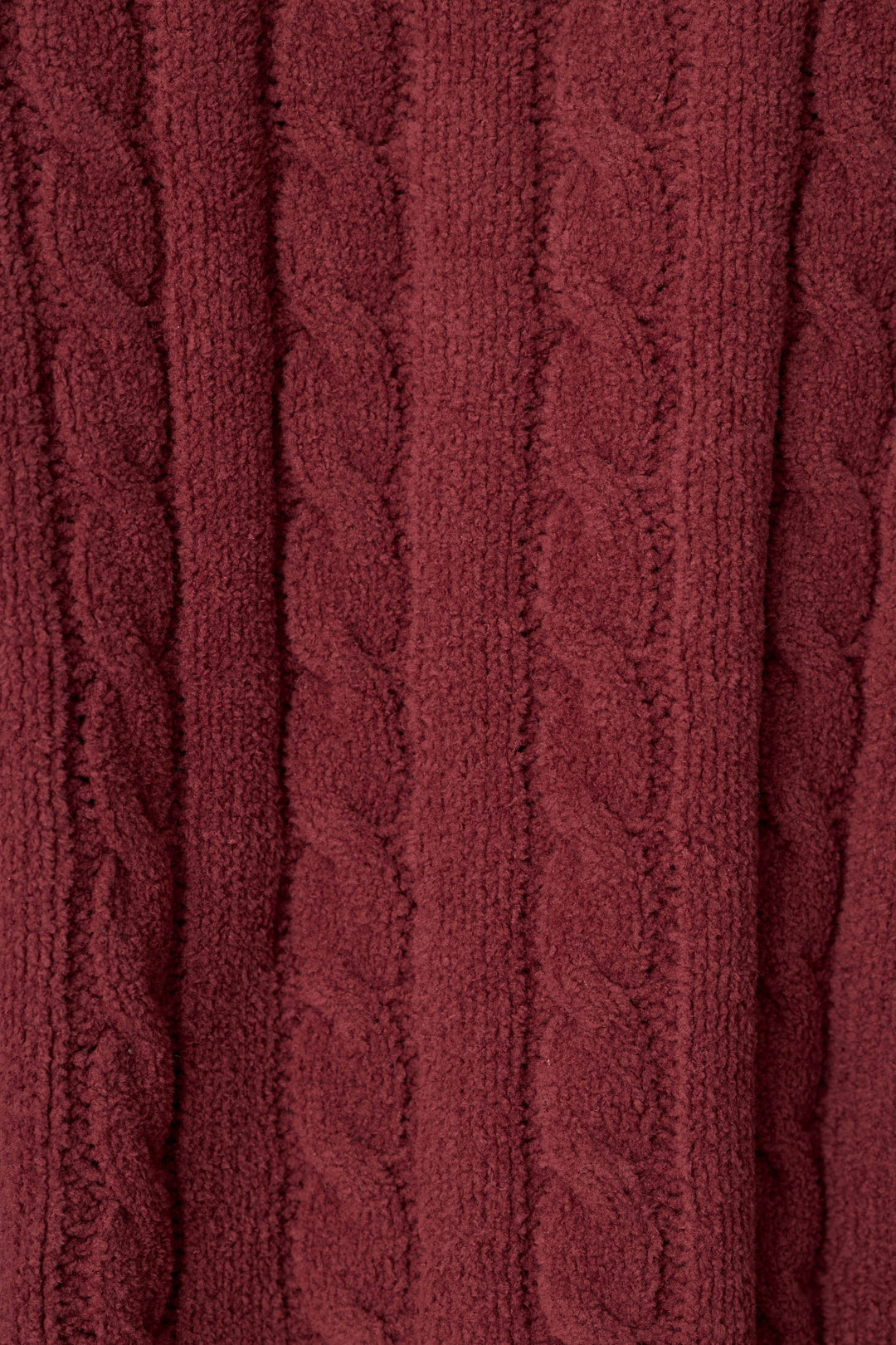 A close-up of a dark win, maroon colored cable-knit fabric texture, showing the detailed knit pattern and soft folds.