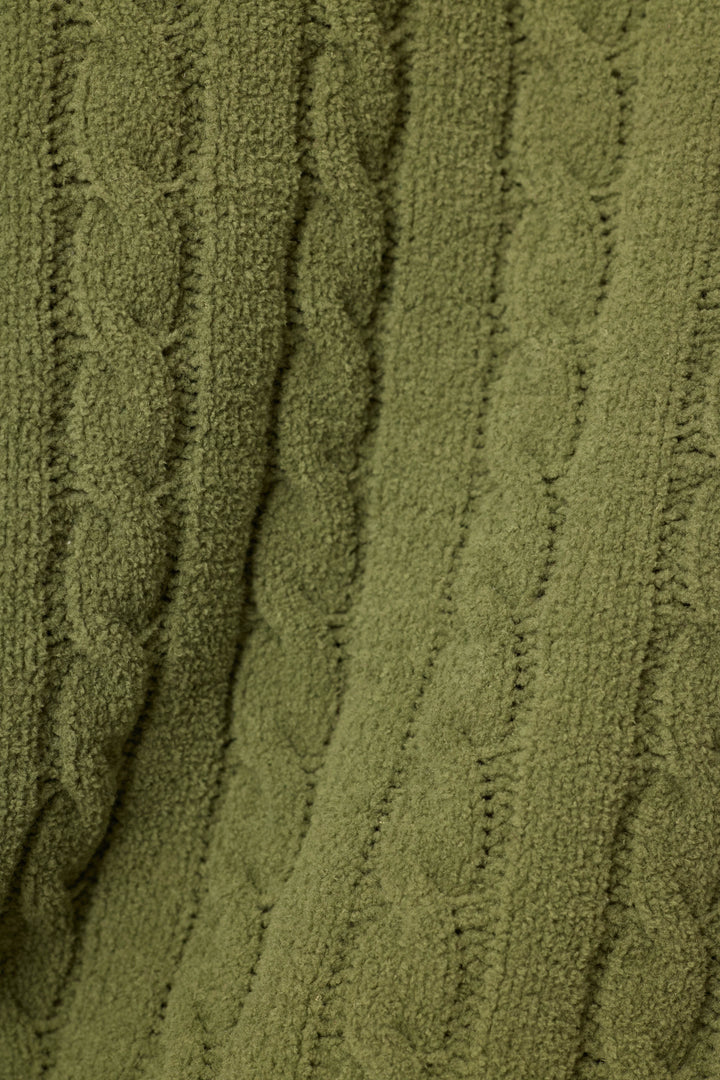 Close-up of a textured cable-knit fabric in an olive green color, showing the detailed knit pattern and ribbed vertical rows.
