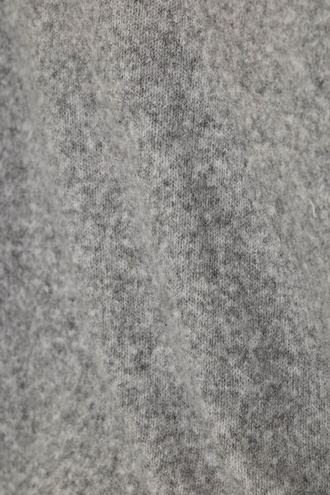 Close-up of a fuzzy, heather gray knit fabric texture.