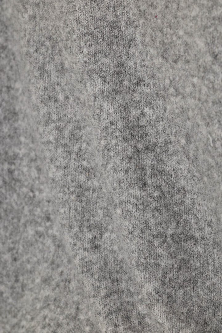 Close-up of a fuzzy, heather gray knit fabric texture.
