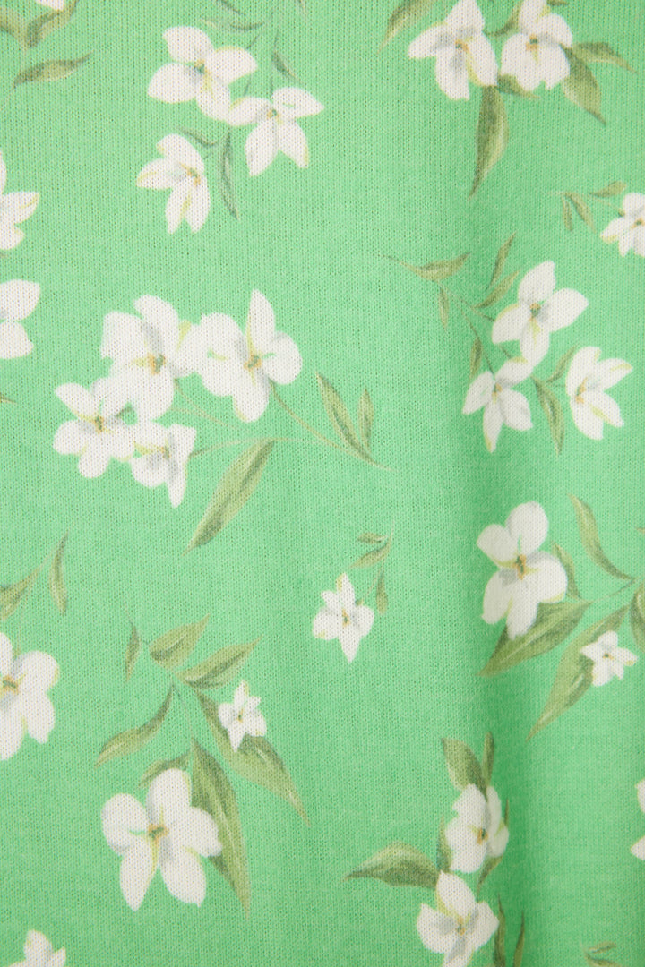 The C'est La Vie Floral Print Long Sleeve Top by P.J. Salvage features green fabric with a printed pattern of white flowers and light green leaves.