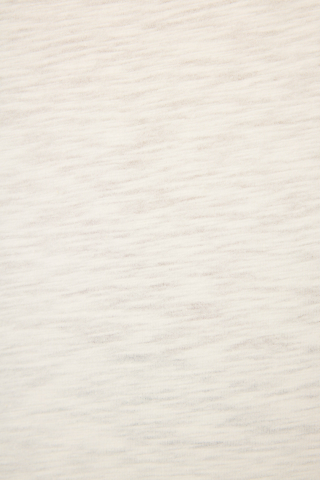 Close-up of the C'est La Vie Graphic Print Short Sleeve Top by P.J. Salvage, showing its light beige fabric with subtle horizontal texture and faint lines, emphasizing the soft, woven material without distinct patterns.