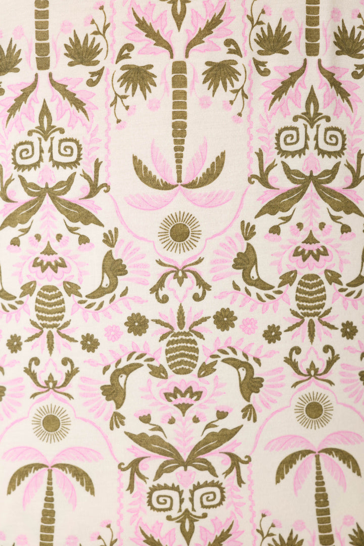 The fabric displays a symmetrical pattern of stylized palm trees, birds, and floral motifs in olive green and soft pink on cream.