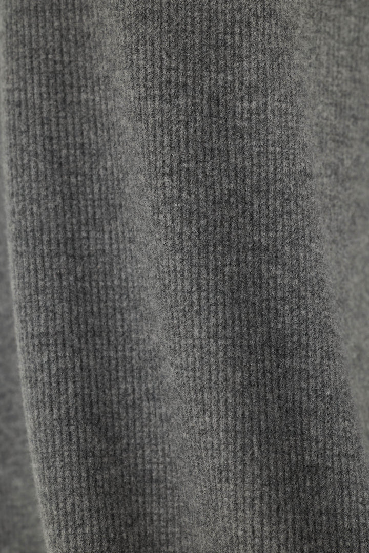 Close-up of a solid, dark gray waffle knit fabric texture.