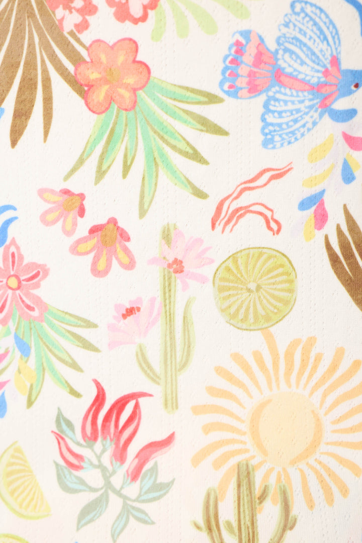 The Feelin' Prickly Desert Dreams Long PJ Set by P.J. Salvage features a bright, playful print with tropical flowers, leaves, a blue bird, cactus, citrus slices, and sun shapes on a light background—perfect for cozy lounging.