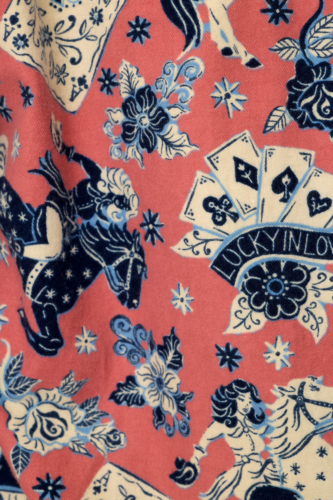 The Lucky in Love Western Print 3-Piece Long Sleeve Flannel PJ Set by P.J. Salvage showcases a whimsical, vintage-inspired design featuring blue horses, roses, floral motifs, playing cards, and a “Lucky in Love” banner on a cheerful pink background.