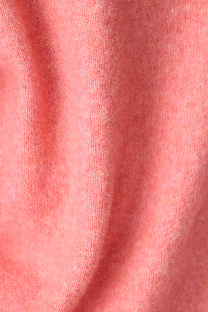 Close-up of the P.J. Salvage Mimosa Please Snuggle Sweater, featuring a soft, textured pink knit with gentle folds and a slightly fuzzy surface.