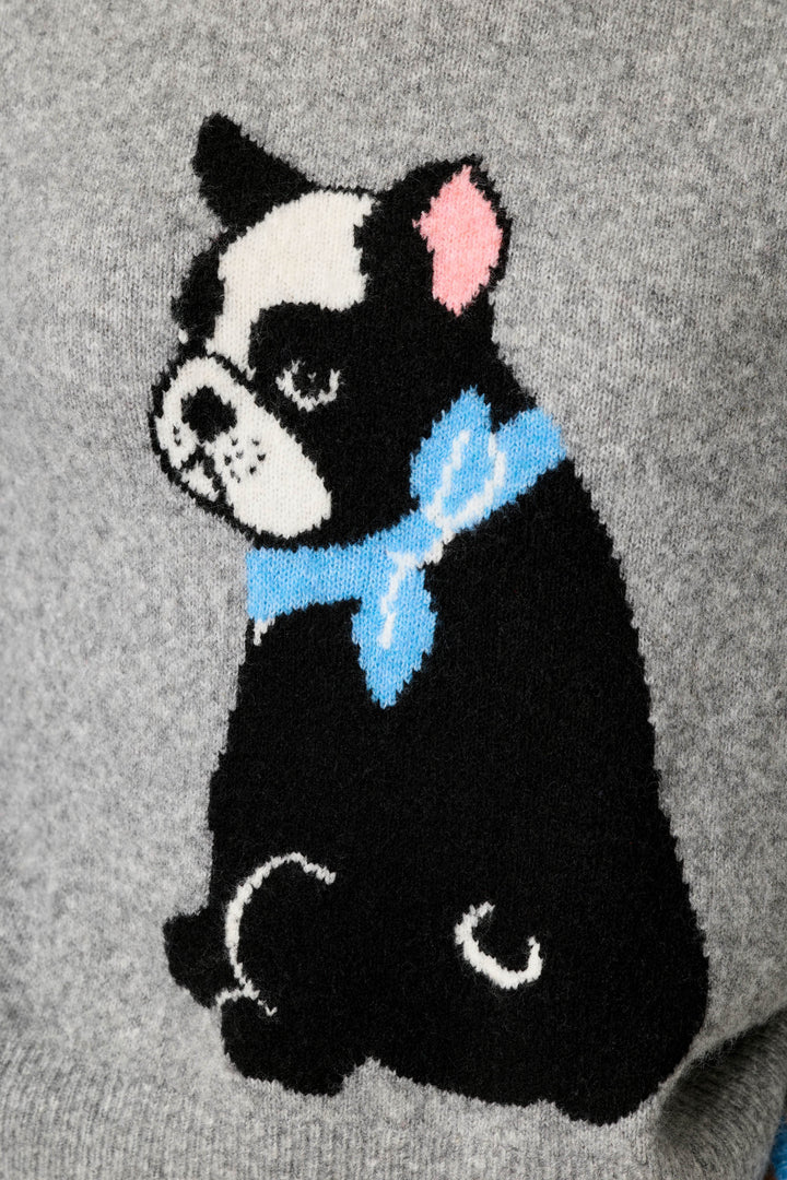 A close-up of a gray knit sweater featuring a black and white French Bulldog design with a light blue bow tie and pink ear.