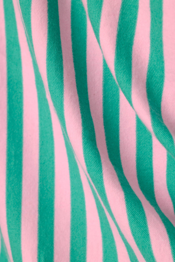 A close-up of a draped fabric with vertical pink and mint green stripes.