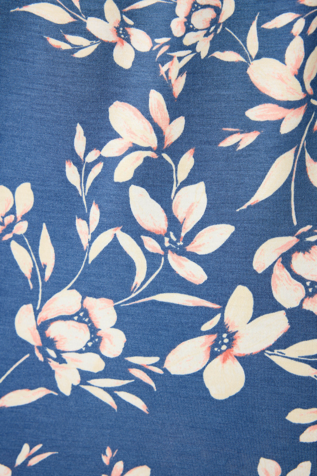 The P.J. Salvage Flora Dreams fabric features a tropical floral print that's white with subtle pink shading on the petals & leaves all on a navy blue background.