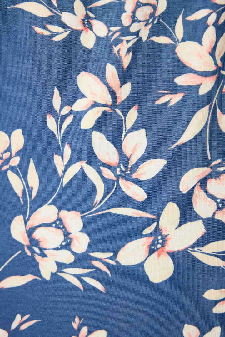 The P.J. Salvage Flora Dreams fabric features a tropical floral print that's white with subtle pink shading on the petals & leaves all on a navy blue background.