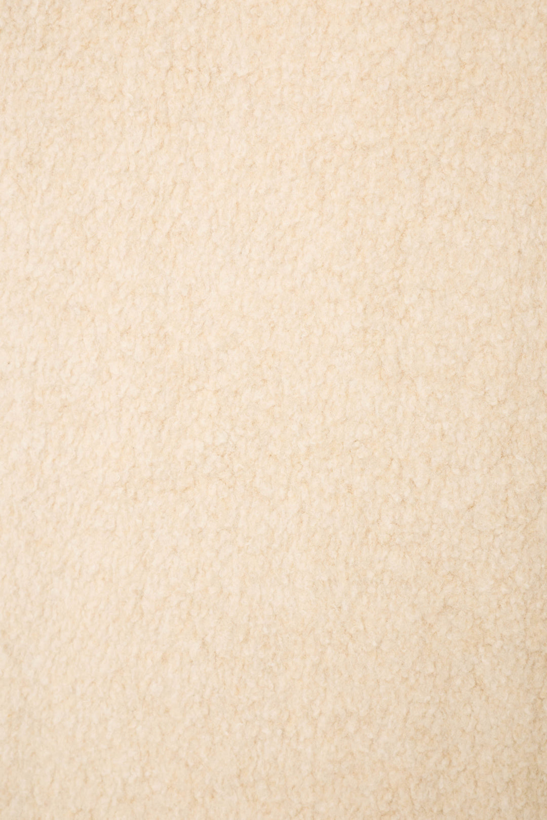 A close-up of soft, beige textured fabric with a plush, fleece-like look—perfect for the For the Mamas Sweetheart Banded Pants by P.J. Salvage.