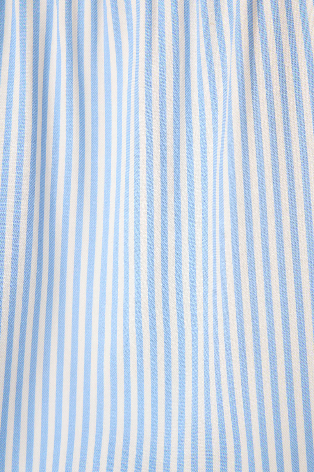 The Frutta Fresca Striped Long Lounge Set by P.J. Salvage features light blue and white vertical stripes on smooth, slightly gathered fabric—delivering a classic, breathable look perfect for sleepwear.