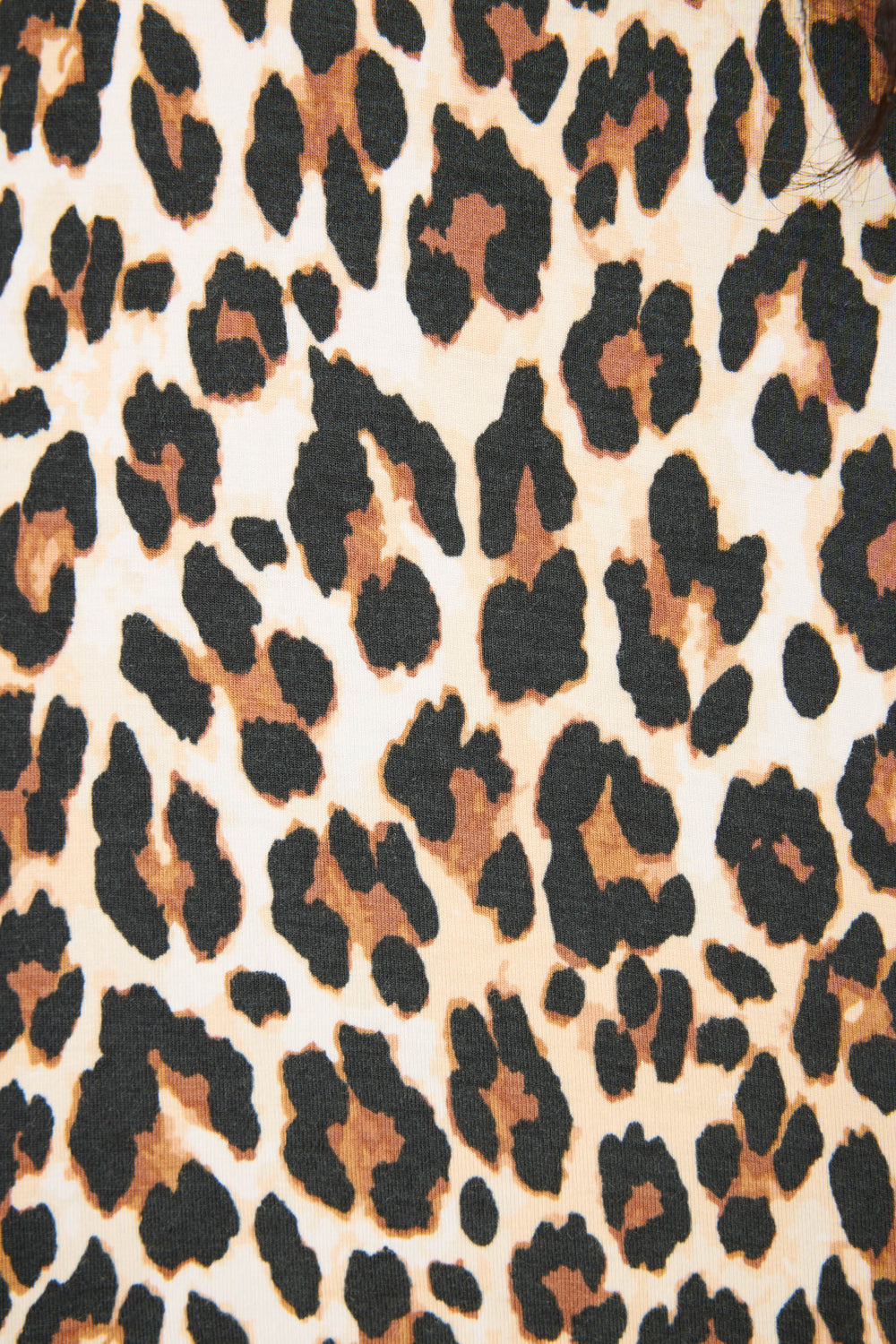 Close-up of P.J. Salvage’s Holiday Dreams Leopard Print Open Leg Pants, featuring a leopard pattern in black, brown, and beige with irregularly shaped spots scattered across the fabric.