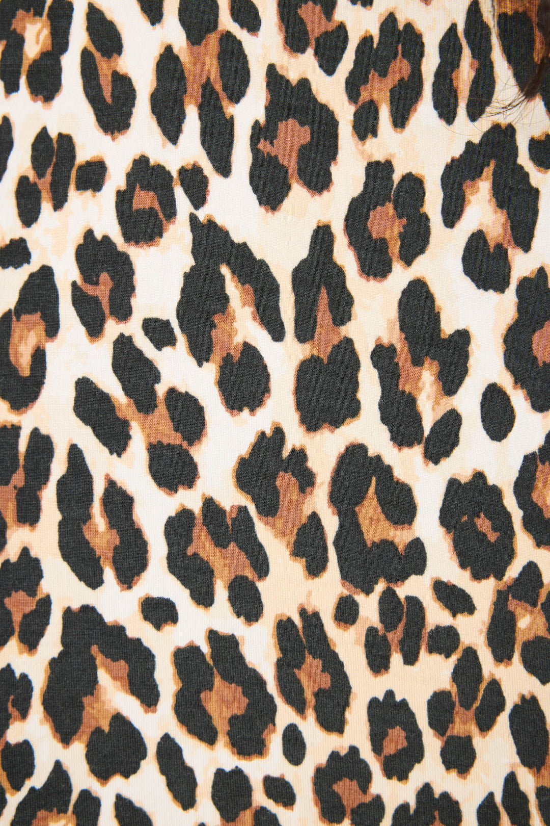 Close-up of P.J. Salvage’s Holiday Dreams Leopard Print Open Leg Pants, featuring a leopard pattern in black, brown, and beige with irregularly shaped spots scattered across the fabric.