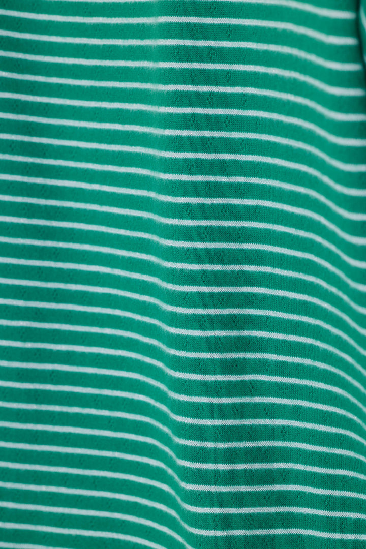 A close-up of a green fabric with thin, evenly spaced white horizontal stripes.