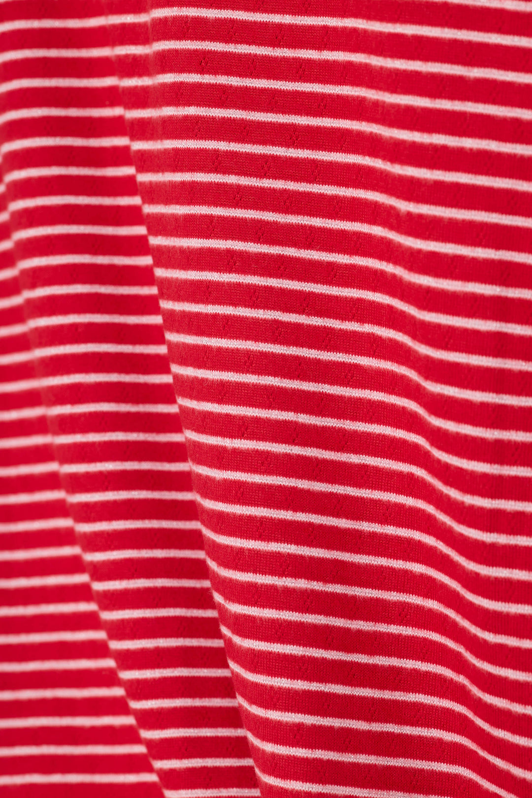 A close-up of a red fabric with thin, evenly spaced white horizontal stripes.
