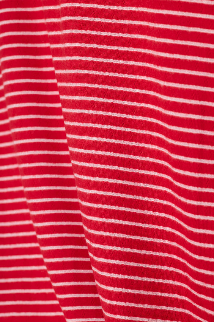 A close-up of a red fabric with thin, evenly spaced white horizontal stripes.