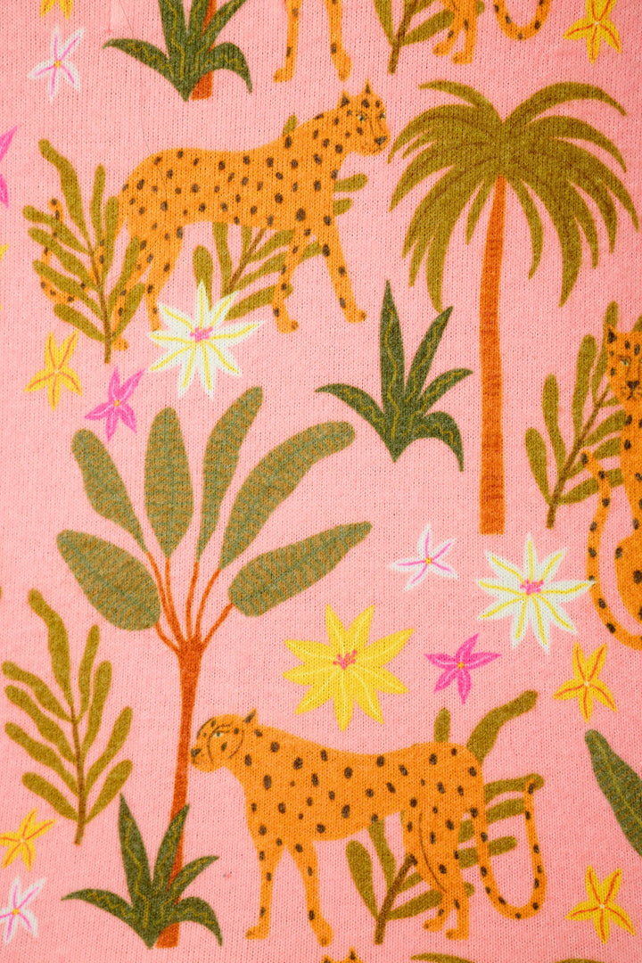The P.J. Salvage "In the Jungle Leopard Safari" fabric features a vibrant jungle print with cheetahs, green tropical plants, palms, and bright flowers on pink fabric.