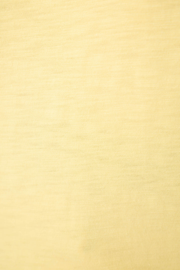 Light yellow fabric with a subtle horizontal texture, soft feel, even color, and faint weave lines visible.