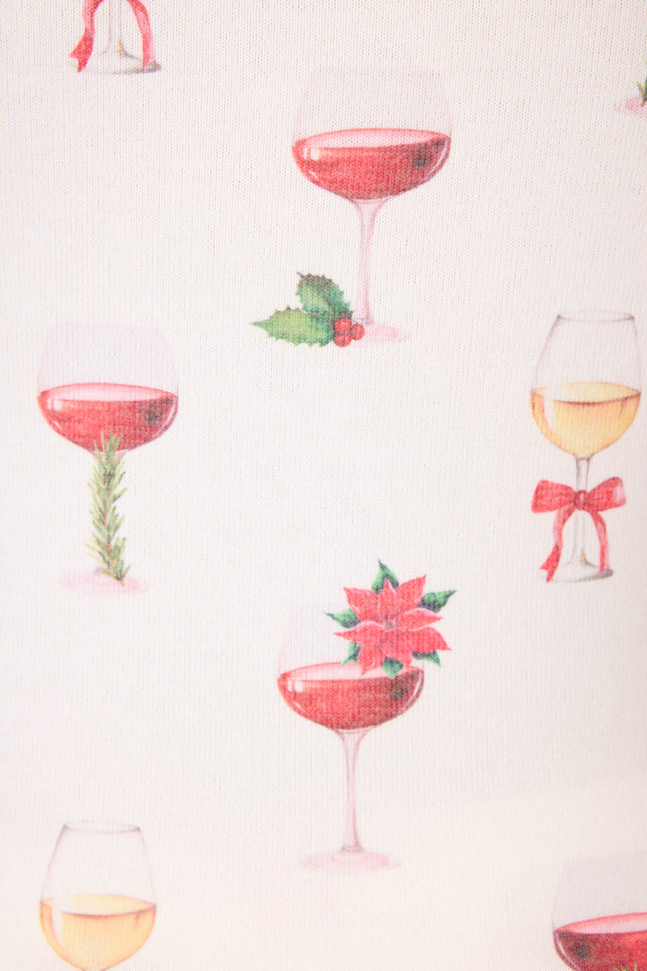 The P.J. Salvage "Let's Get Toasty Holiday Wine Print" tank top features festive champagne and wine glasses—some adorned with holly, rosemary, poinsettias, or red bows—on a crisp white background.