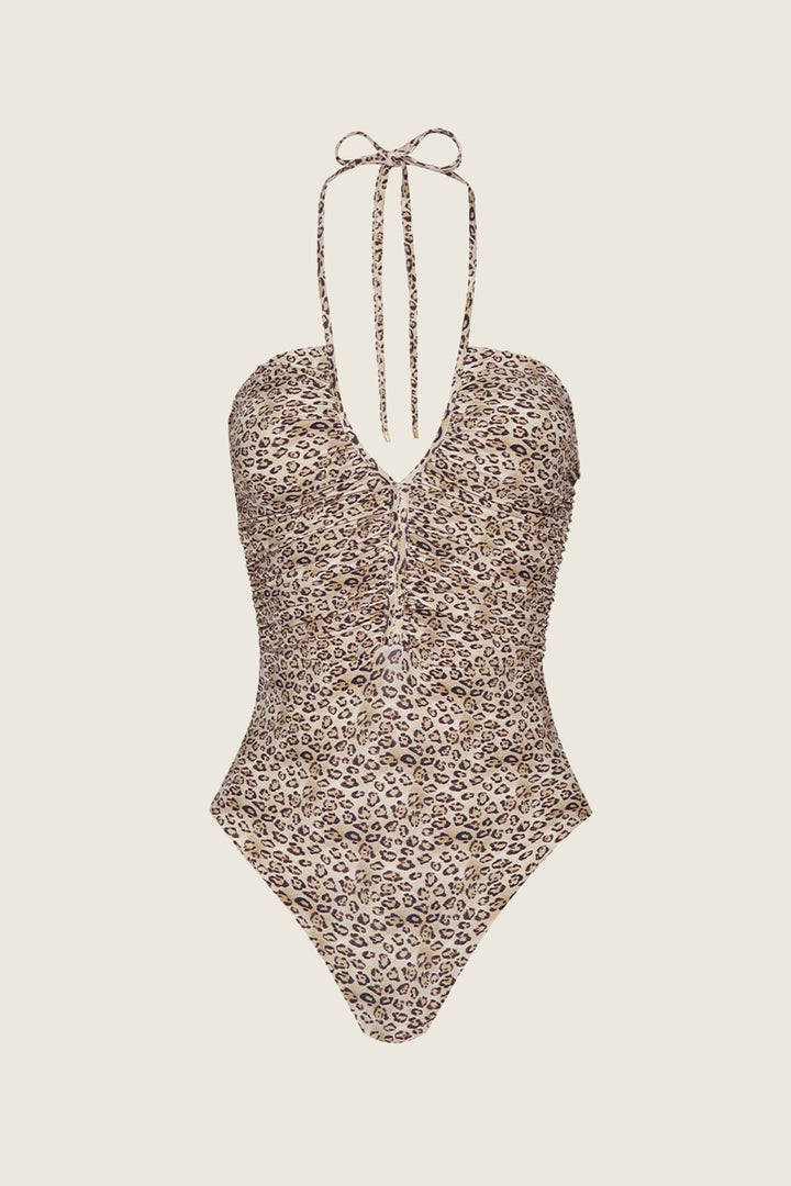 The PQ Swim PJS x PQ Swim Leopard Josie One Piece features a halter neck tie, center ruching, built-in shelf bra, and a brown/beige leopard print on a light background for a flattering fit and moderate leg cut.