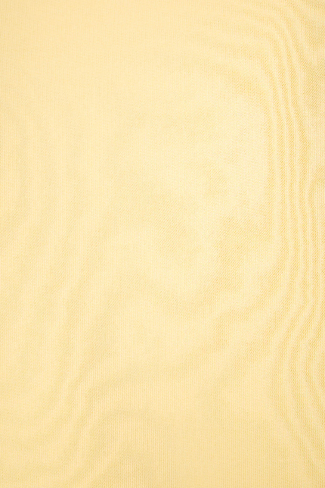 Light yellow textured fabric with subtle vertical lines.