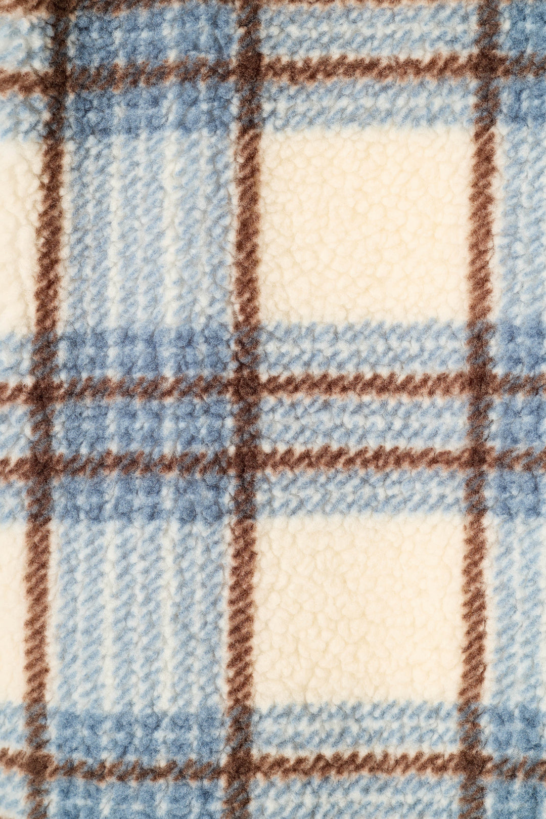 A close-up of a plush fleece fabric with a plaid pattern in light blue, cream, and brown.