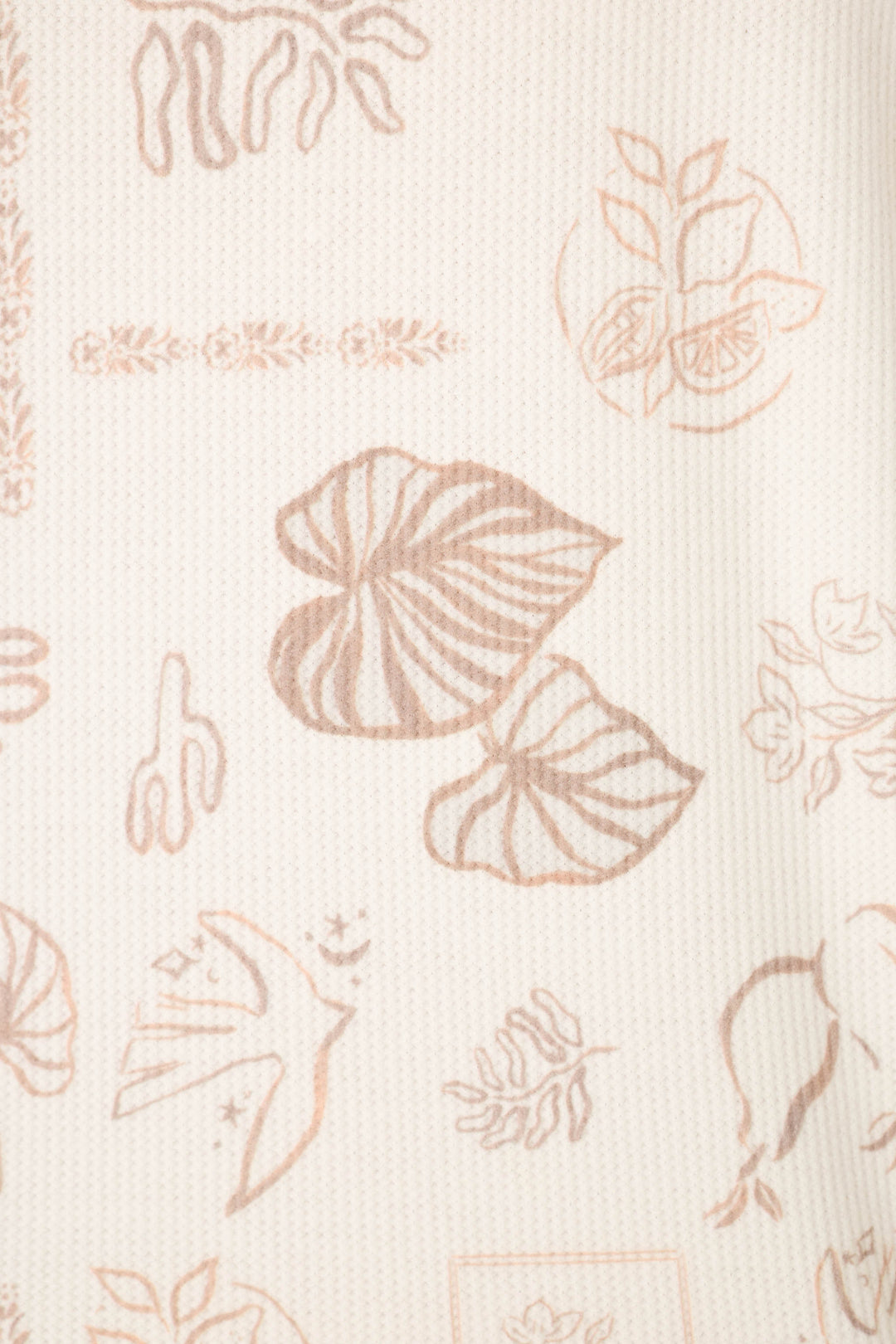 The Palms Away Bistro Botanicals print features a cream-colored fabric adorned with light brown, hand-drawn leaves, flowers, a cactus, birds, and other nature-inspired illustrations.