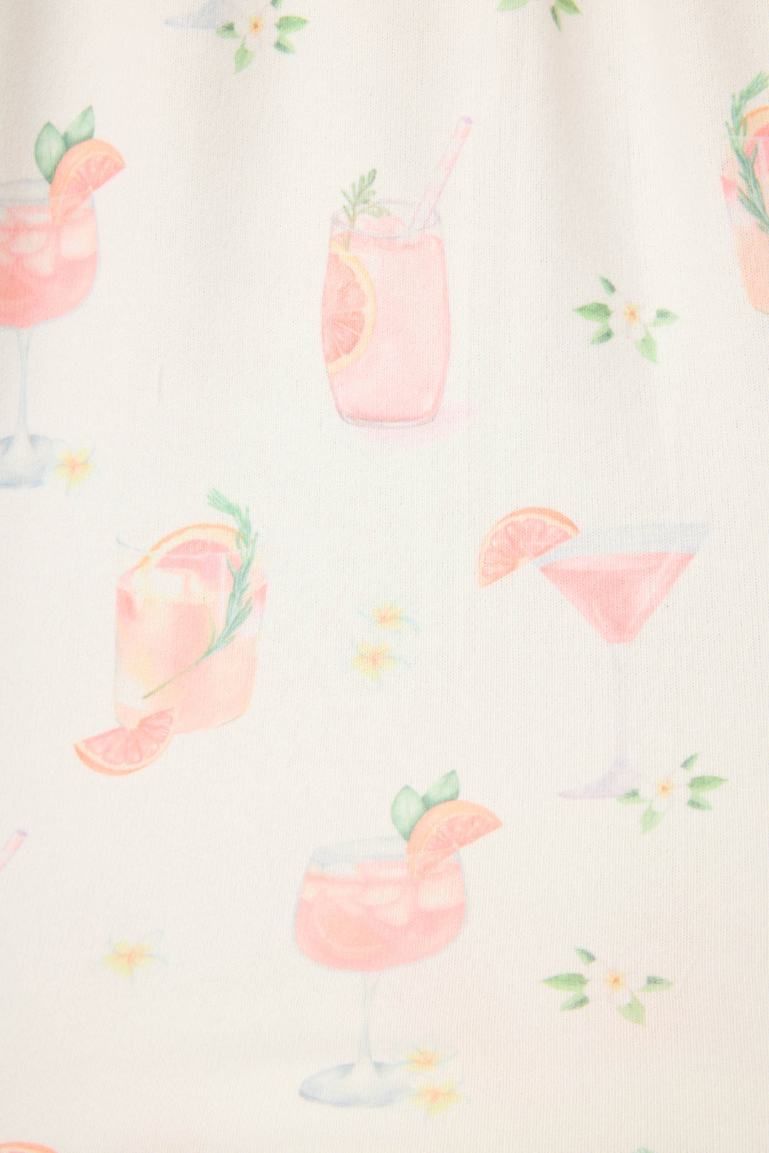 The Paloma Mama Sweet Sips Tank Top by P.J. Salvage features a breathable butter jersey ivory fabric with pink cocktail illustrations, citrus garnishes, herbs, and small white and yellow flowers—a fun sleepwear choice.