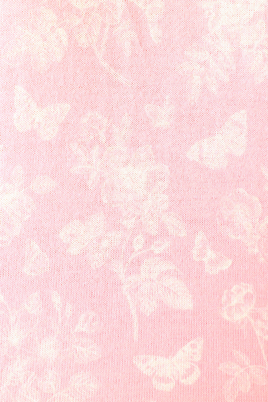 Soft baby pink fabric with white butterfly and floral patterns, creating a delicate, airy appearance.